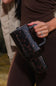 HydroJug Traveler 40 oz Tumbler in Mocha Tortoise model holding a cup 