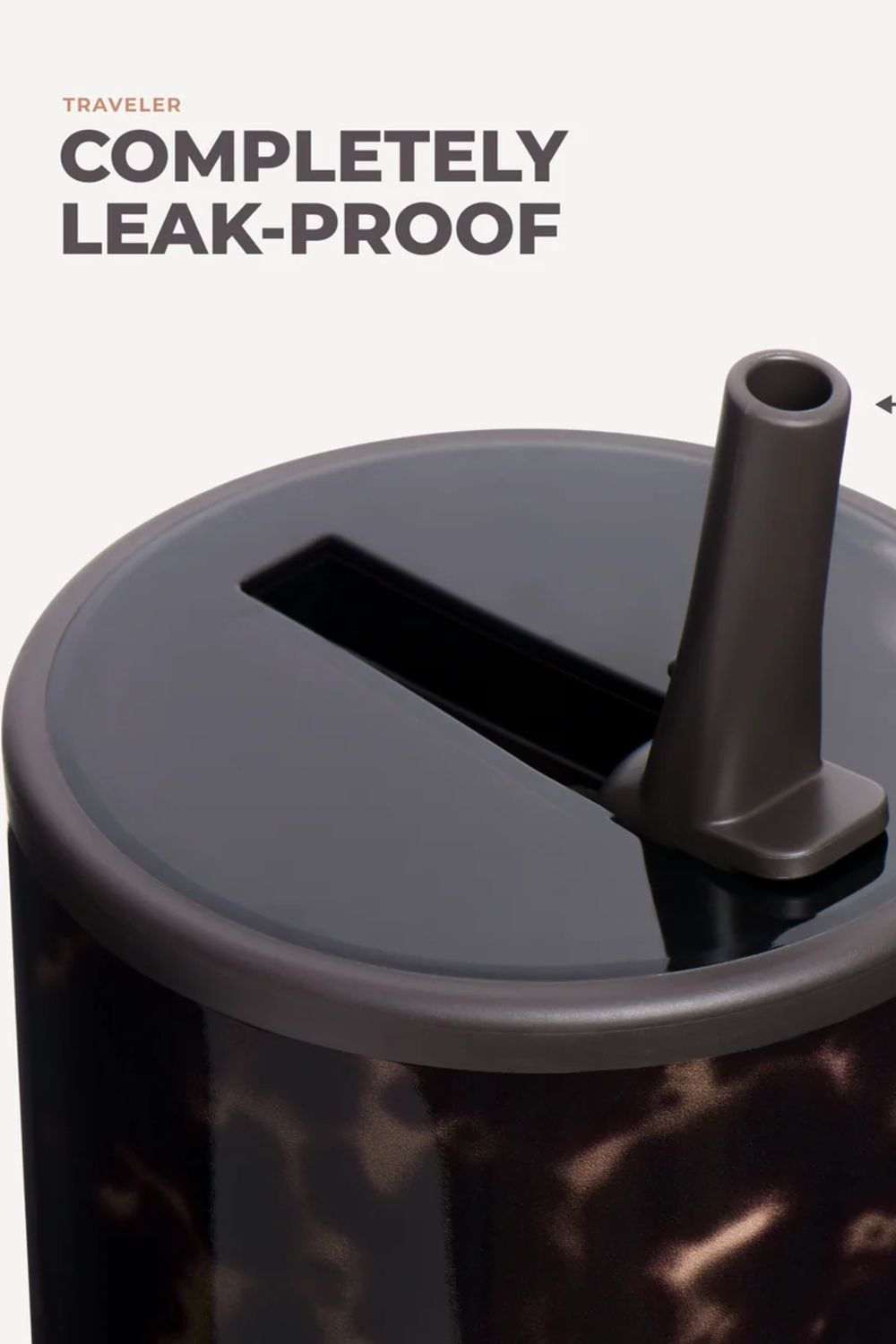 Close-up of a travel tumbler with a dark gray leak-proof lid and straw, featuring a dark brown marbled pattern on the body, with text reading 'TRAVELER COMPLETELY LEAK-PROOF' on a light background.