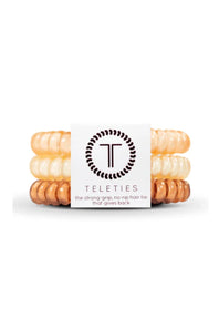 Stack of hair ties with 'Teleties' packaging on a white background