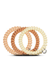 Set of three beaded bracelets in beige, brown, and white on a white background