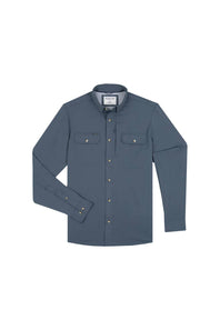 A long-sleeve button-up shirt in slate blue, featuring two chest flap pockets with snap buttons and gold-tone metal snaps, displayed on a clean white background.