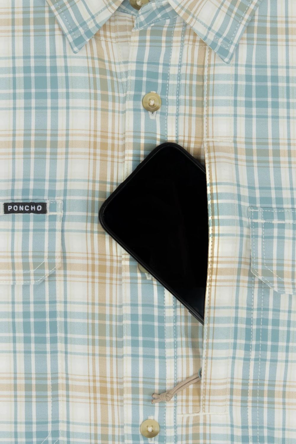 Close-up of a light blue, beige, and white plaid button-down shirt with a black smartphone tucked into the chest pocket. A small black brand tag on the pocket reads PONCHO.