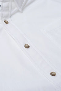 Close-up of a white button-up shirt showing the front placket with metallic brown buttons and part of the collar.