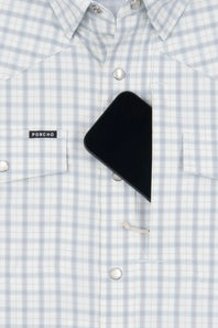 Close-up of a light blue and white checkered button-down shirt with a black smartphone tucked into one of the chest pockets. A small black brand label on the pocket reads PONCHO.