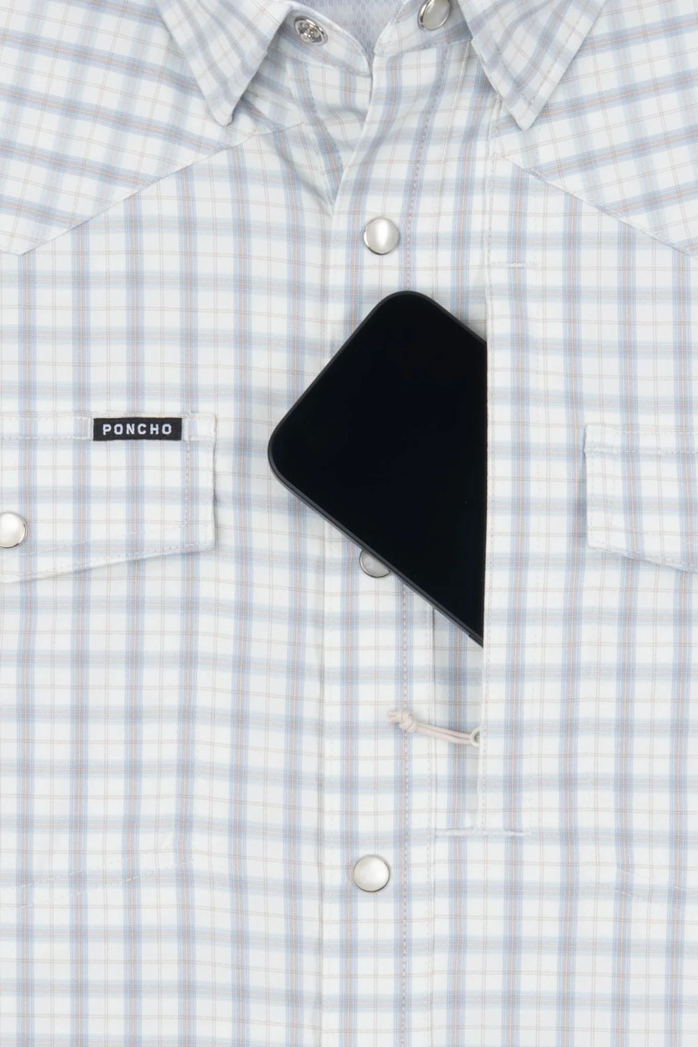 Close-up of a light blue and white checkered button-down shirt with a black smartphone tucked into one of the chest pockets. A small black brand label on the pocket reads PONCHO.