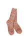 A pair of hand-knit socks featuring a marled, heathered pattern of orange, pink, red, and cream yarn, displayed against a solid white background.