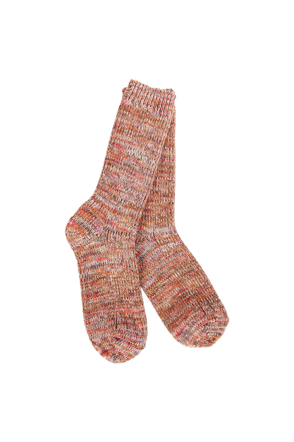 A pair of hand-knit socks featuring a marled, heathered pattern of orange, pink, red, and cream yarn, displayed against a solid white background.