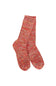 A pair of hand-knit crew socks in a heathered marled pattern of red, orange, and beige yarn, shown against a plain white background.