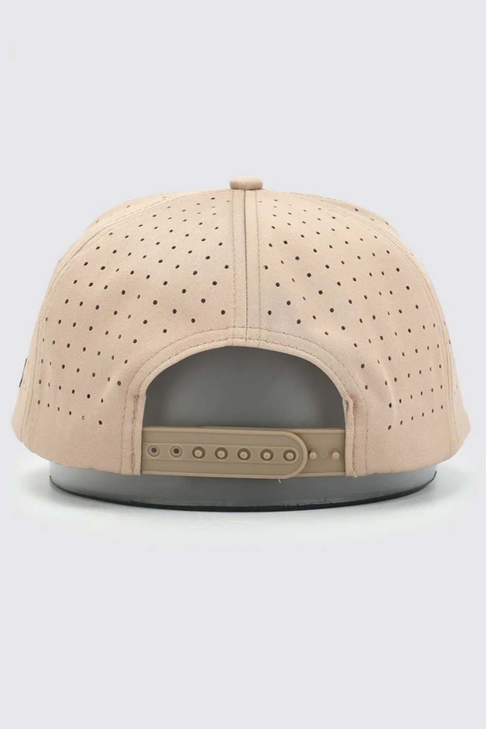 A beige snapback cap viewed from the back, featuring a perforated fabric crown and a matching beige adjustable strap on a dark gray base.