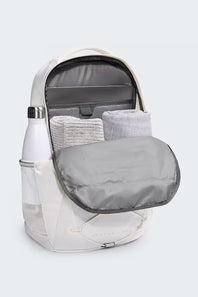 White backpack with gray interior and mesh side pocket on a light gray background