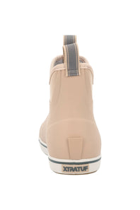 A single XtratuF ankle rain boot shown from the back, featuring a light beige nylon upper, a gray pull tab, and a white sole with a black stripe and XTRATUF branding.