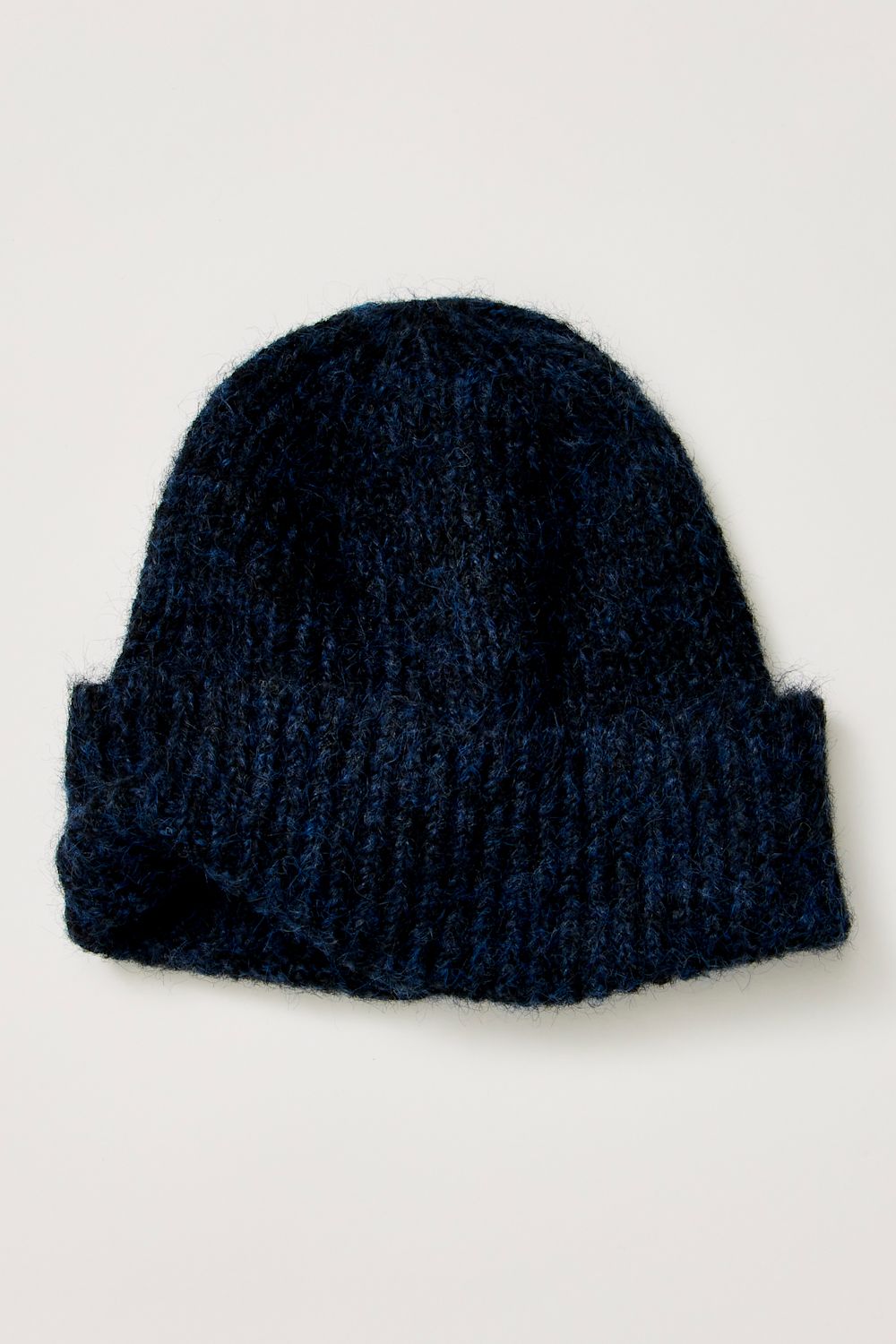 A dark navy blue knit beanie hat with a folded cuff, shown against a plain off-white background.