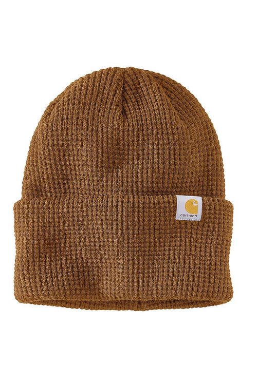 A brown waffle-knit beanie hat with a folded cuff and a small white Carhartt logo patch on the side, shown against a plain white background.