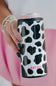 Hand holding a can with a black and white cow print design and 'KATYDID' branding.