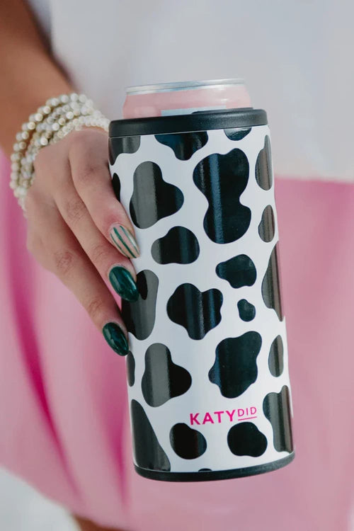 Hand holding a can with a black and white cow print design and 'KATYDID' branding.