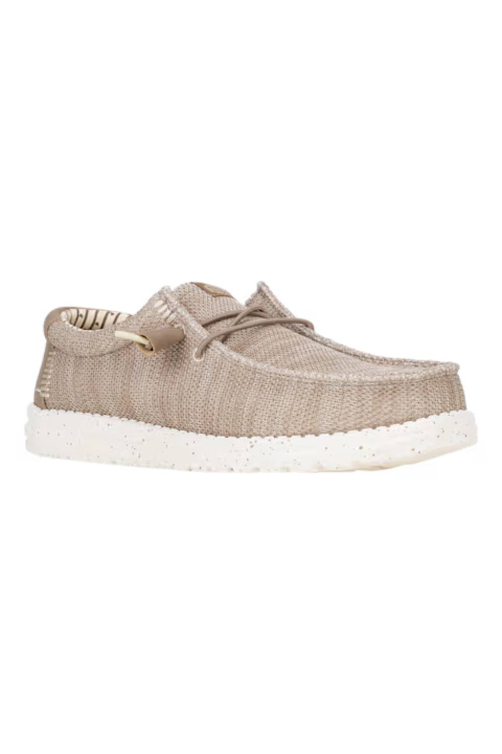 A single woven slip-on shoe in a light taupe-beige color with a white speckled sole, shown against a plain white background.