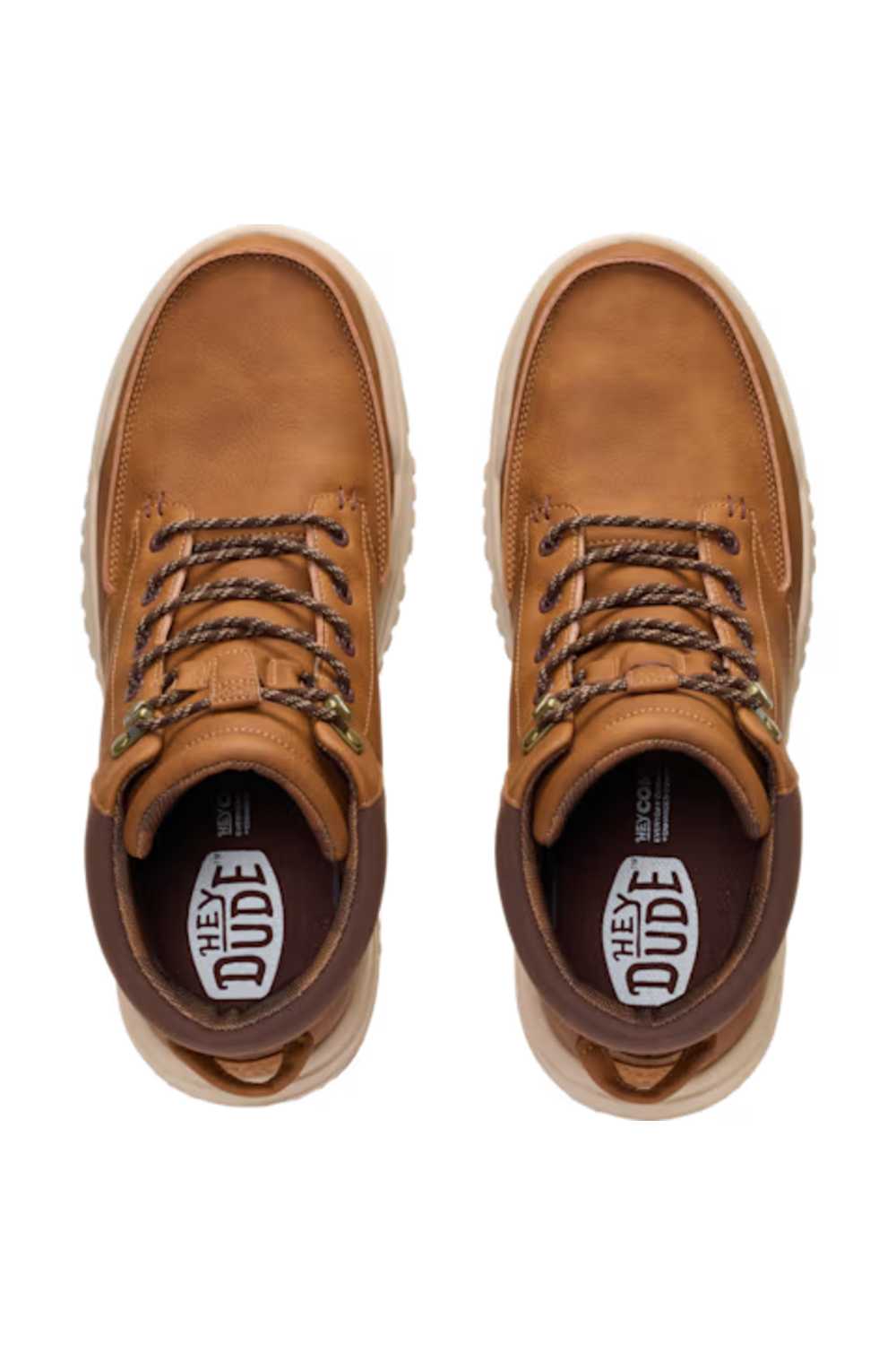 Overhead top-down view looking directly inside a pair of HEYDUDE Men’s Bradley II Classic Boots in Argan Oil brown, highlighting the branded insoles, dark brown padded collars, speckled laces, and smooth faux-leather toe caps.