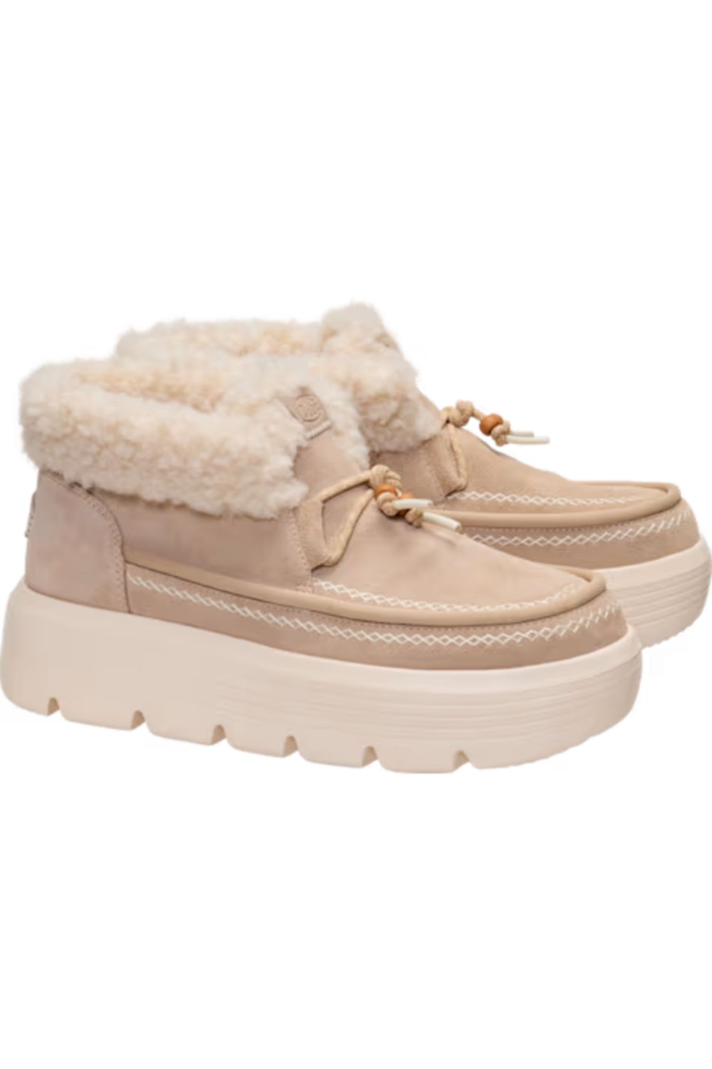 A pair of beige platform slip-on shoes with fluffy cream faux-fur lining and decorative gold-tone bow details, shown against a plain white background.