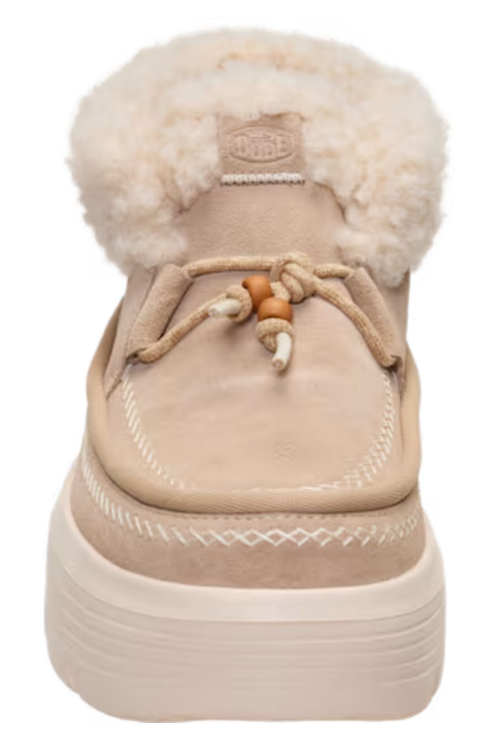 A beige suede slip-on boot with a thick cream platform sole, a fluffy cream shearling collar, and decorative tan and cream laces, shown from a front-facing angle on a white background.