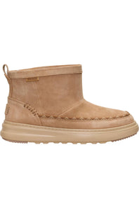 A tan suede ankle boot with a thick beige sole, featuring decorative stitching around the toe and a small 'HEYDUDE' brand tag on the side.