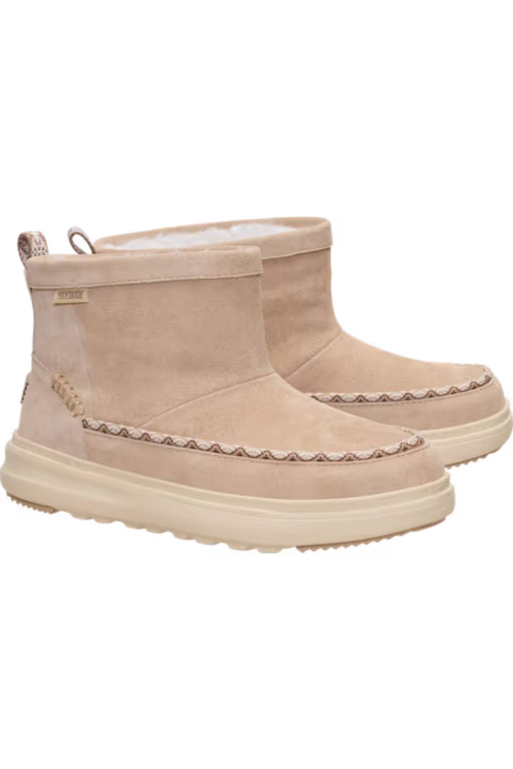 A pair of beige suede ankle boots with cream-colored soles and a decorative zigzag stitch detail around the midsole, shown against a plain white background.