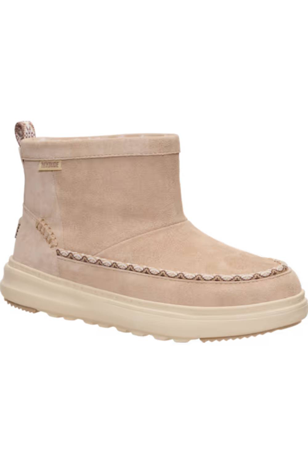 A single ankle suede boot in a light beige or taupe color, featuring a thick cream-colored sole and decorative stitching along the vamp, shown against a plain white background.