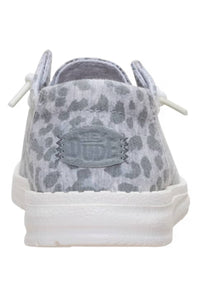 A low-top canvas sneaker shown from the back, featuring a gray and white leopard print pattern on the upper, white laces, and a thick white rubber sole.