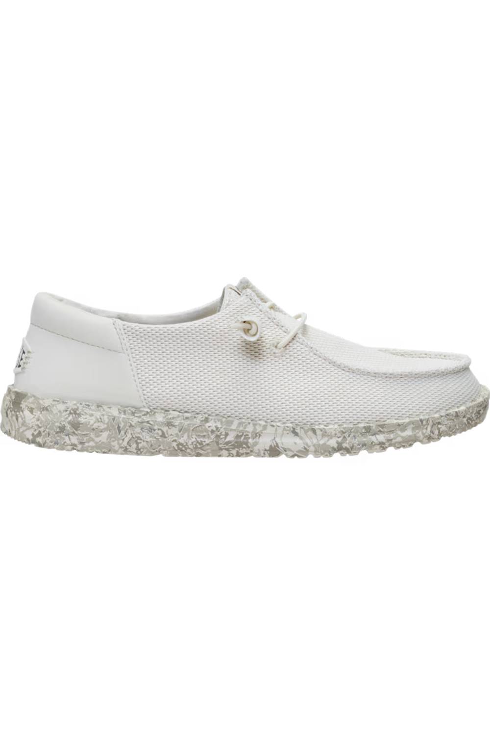 A white slip-on shoe with a textured mesh upper, matching white laces, and a chunky, speckled white sole, shown against a plain white background.