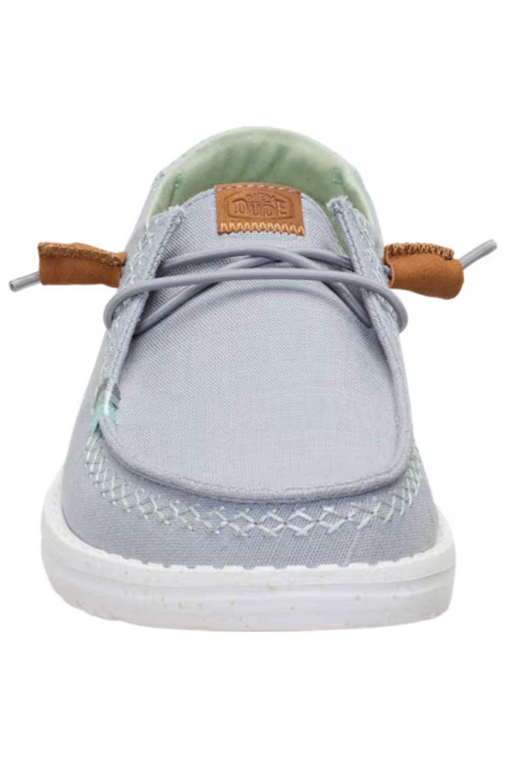 A light gray canvas boat shoe with a white sole, featuring light brown leather laces and a tan brand patch on the tongue.