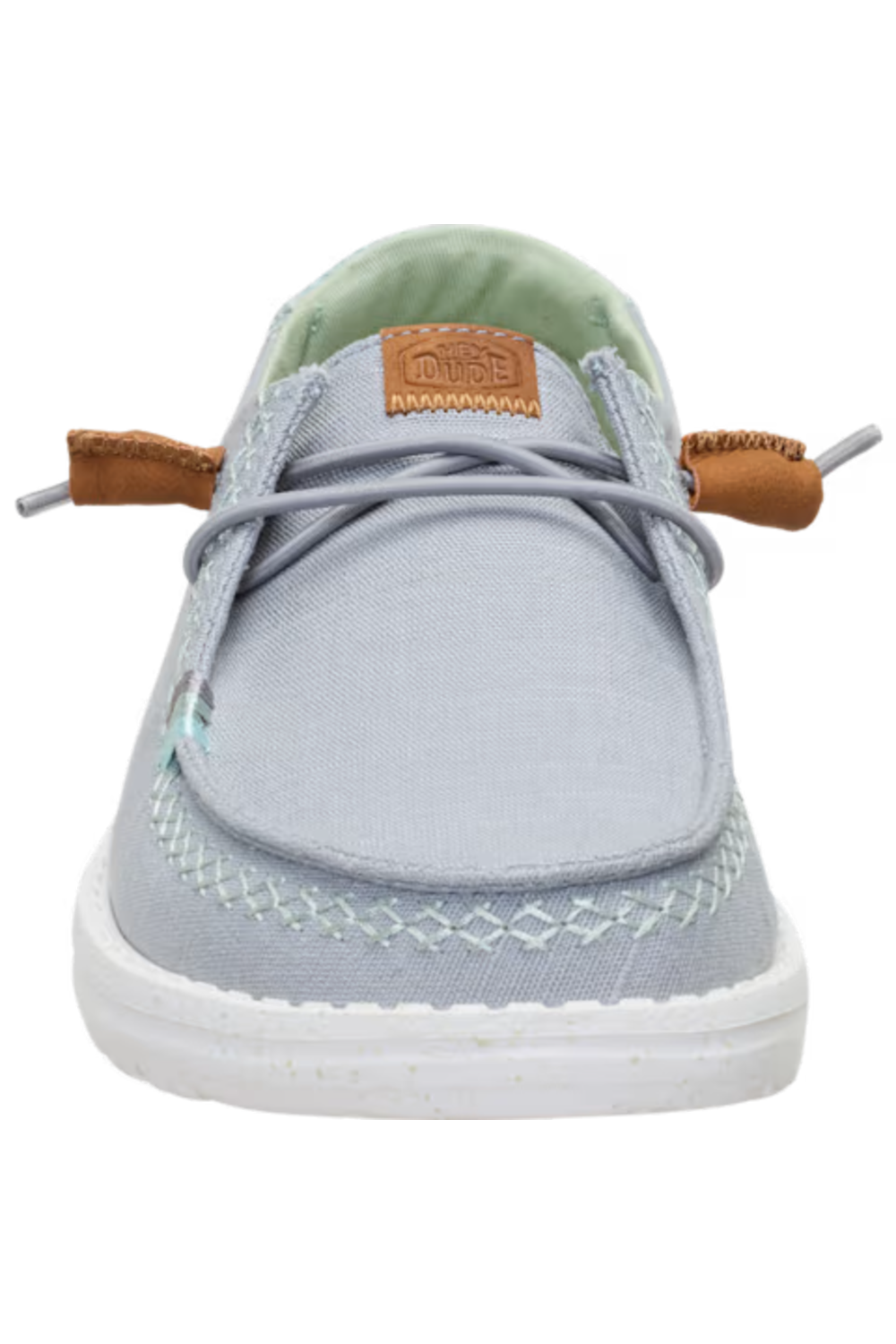A light gray canvas boat shoe with brown leather laces, a white sole, and a light green interior lining, shown from a front-facing perspective on a white background.
