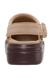 A single platform clog shoe shown from the back, featuring a beige suede upper with a hook-and-loop strap and a thick dark brown platform sole, set against a plain white background.
