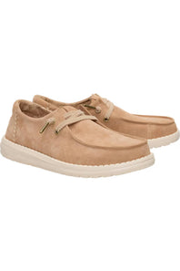A pair of tan suede boat shoes with matching laces and off-white soles, displayed against a plain white background.