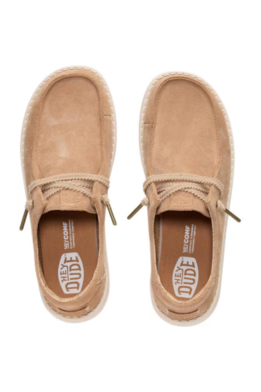 A pair of beige suede slip-on shoes with rope laces and a braided jute trim, shown from a top-down view on a white background. The insole features the 'HEY DUDE' and 