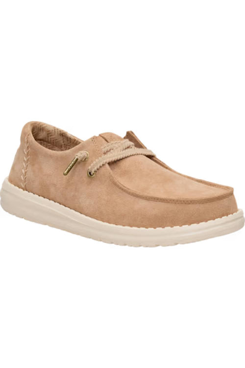 A light tan suede boat shoe with matching laces and a thick white sole, shown from a side angle on a white background.