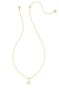 A delicate gold chain necklace featuring a small, polished gold heart pendant, displayed on a clean white background.