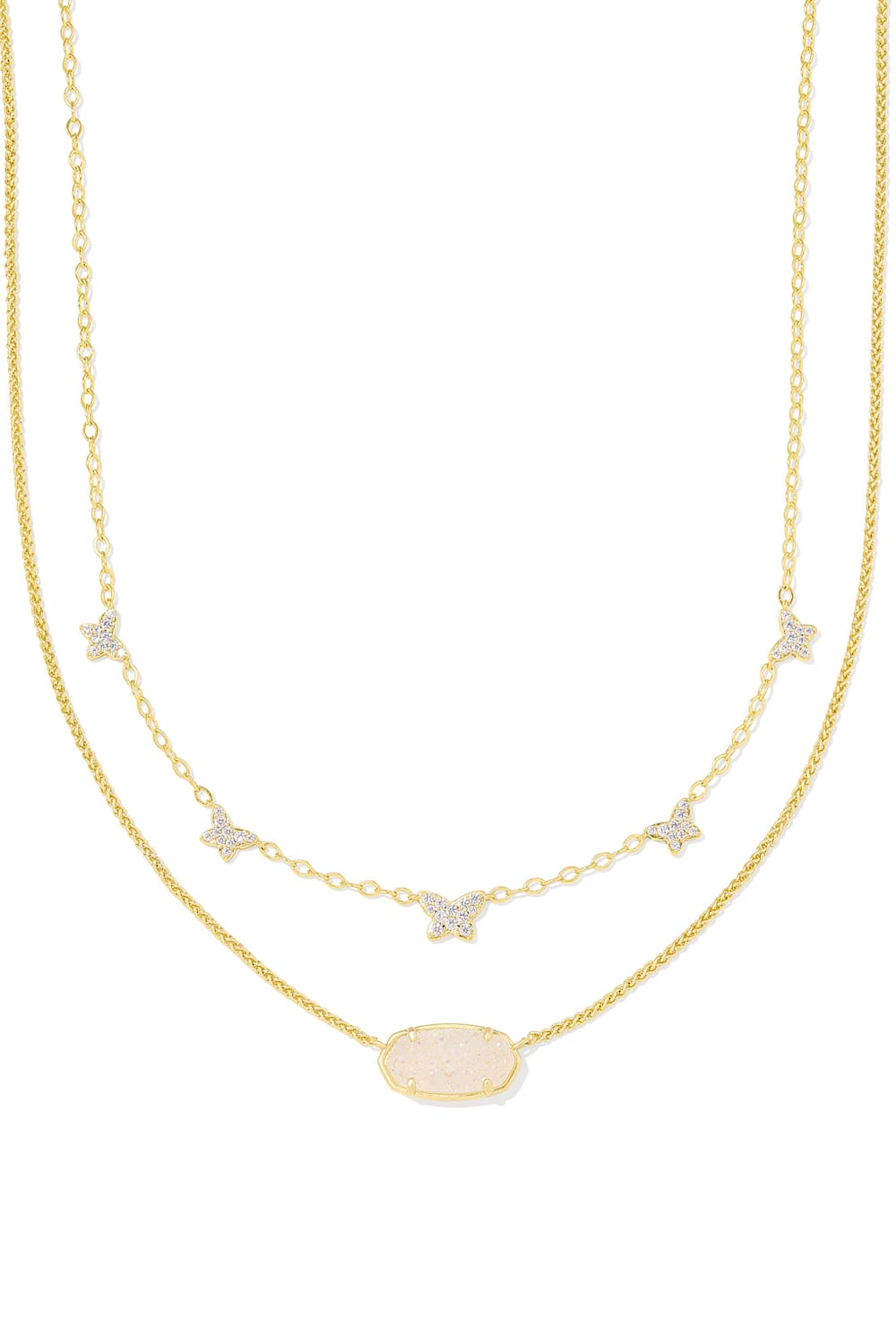 A double-strand gold necklace featuring a delicate chain with small star and bow charms set with clear stones, and a central oval pendant with a pale pink opal-like inlay, shown on a plain white background.