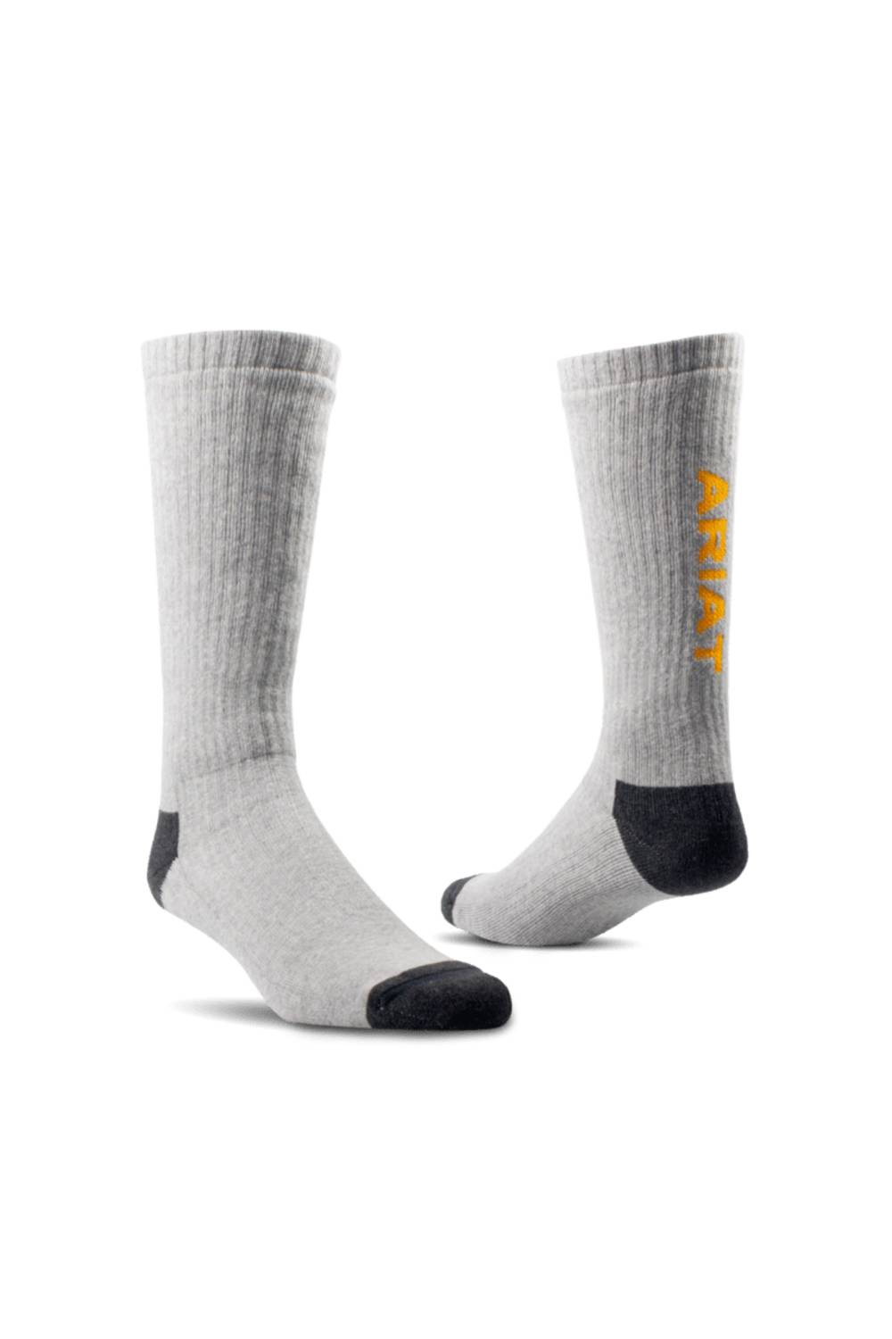 A pair of light gray ribbed crew socks with black toe and heel accents, featuring the brand name 'Ariat' printed vertically in yellow on the side of one sock, set against a plain white background.