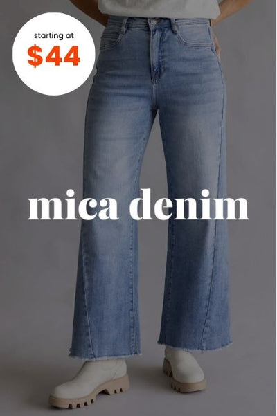 A person wearing high-waisted, light-wash wide leg jeans and beige boots. The white text mica denim is centered across the legs, and a white circular badge in the top-left corner reads starting at $44 in orange text
