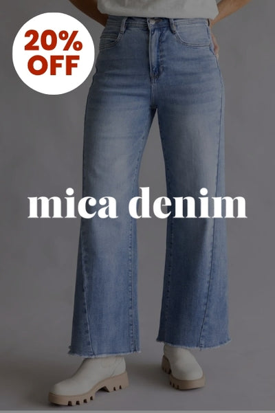 Promotional graphic with a person wearing a pair of slim wide leg jeans in front of a basic background with an image overlay darkening the image. The Mica Denim logo in white is in the center of the image and a circular callout in the upper left corner that reads 20% OFF