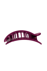 A single dark purple plastic hair claw clip shown against a plain white background.