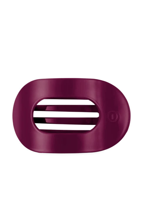 A dark magenta hairclip with a vented design and a small circular logo on the right side, shown on a plain white background.