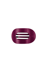 A dark magenta-purple oval hair clip with three horizontal slits, shown on a plain white background.