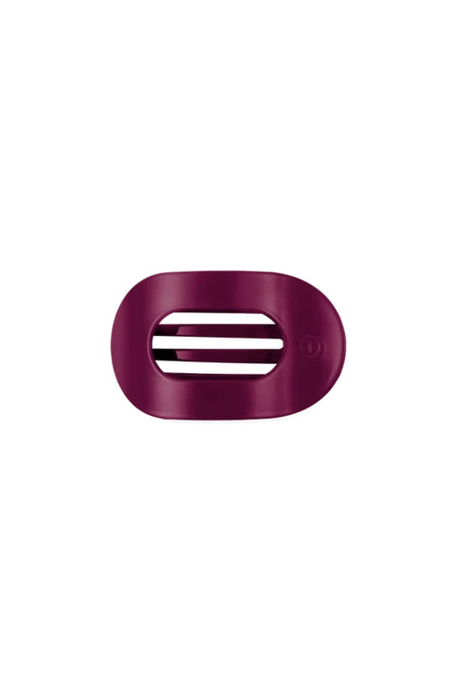 A dark magenta-purple oval hair clip with three horizontal slits, shown on a plain white background.