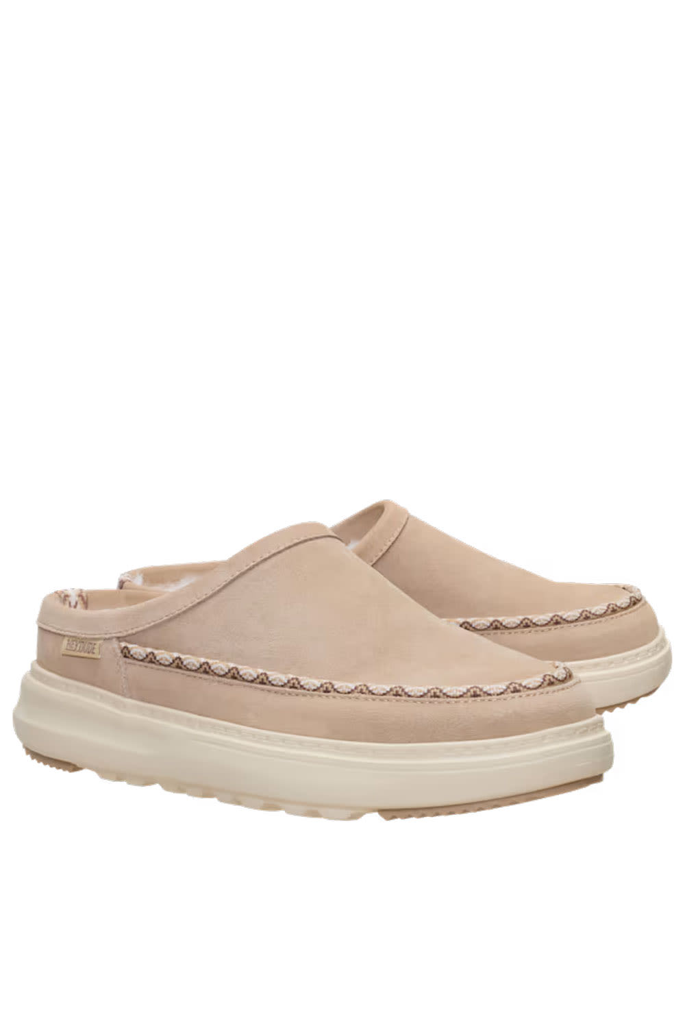 A pair of slip-on clogs in light beige suede with decorative stitching and thick cream-colored soles, shown against a plain white background.