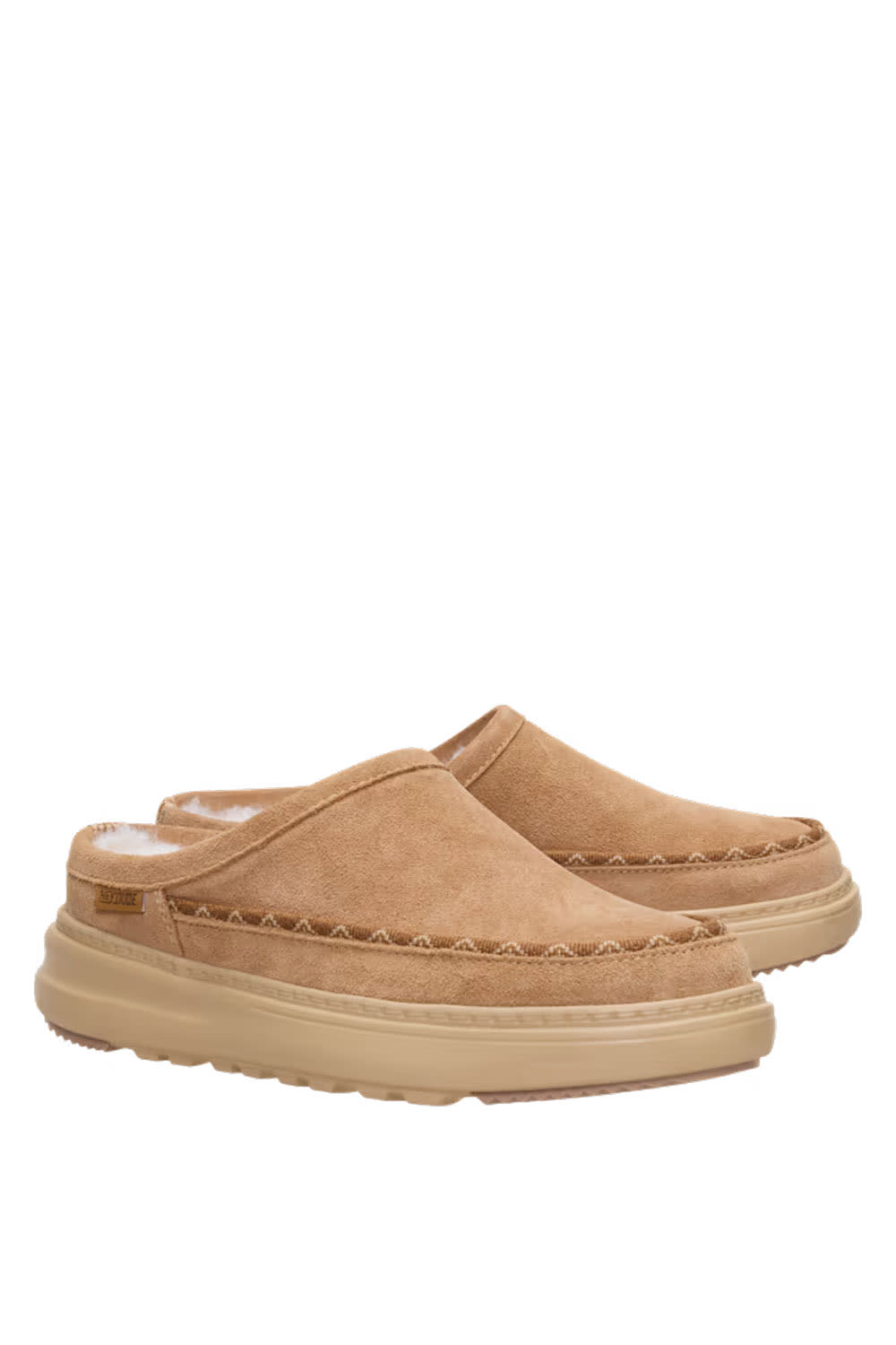 A pair of tan suede slip-on clogs with thick beige platform soles and decorative stitching, shown against a plain white background.