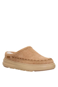A single tan suede clog-style slipper with a thick beige sole, shown from a side profile on a solid white background.