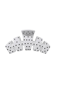 A white claw-style hair clip featuring black printed dots on a clean white background.
