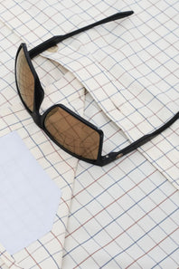 Black Wayfarer-style sunglasses with dark lenses, shown at an angle on a clean white background.
