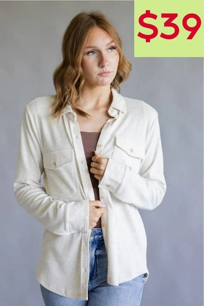 Woman wearing a oatmeal colored overshirt in front of a plain background with a $39 price callout in the upper right hand corner of the image