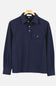A dark navy blue long-sleeve polo shirt with a pointed collar, three-button placket, and a chest pocket with a snap closure, hanging on a wooden hanger against a light gray background.